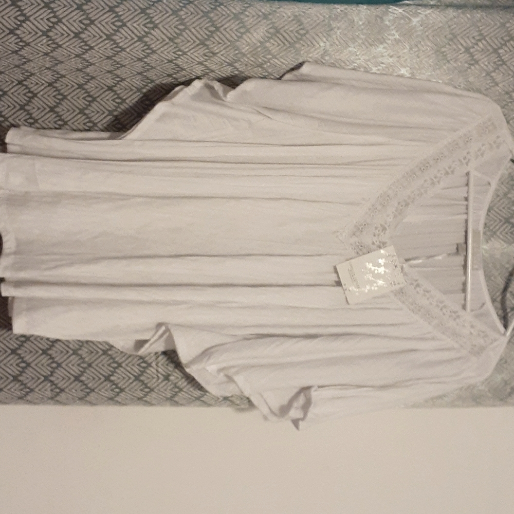 White blouse with circular sleeve.